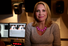 Andrea Canning in front of monitors during news editing