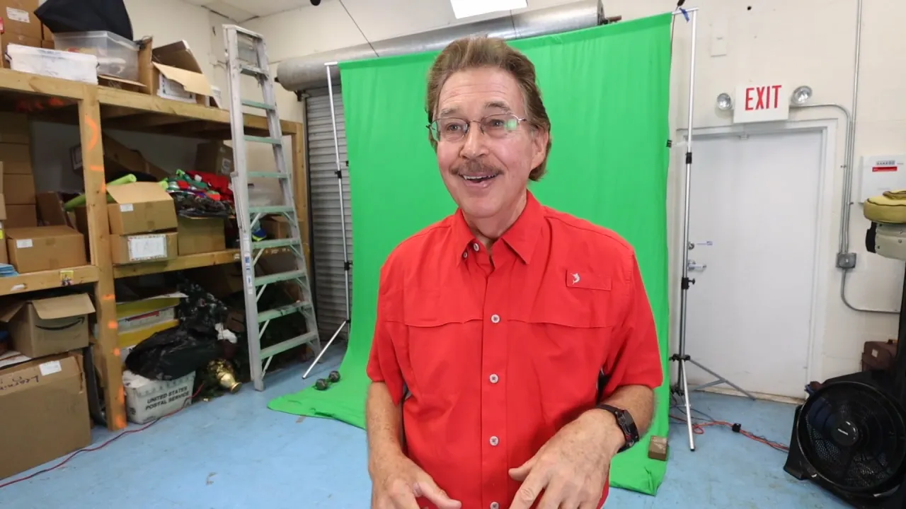 Jack Hartmann smiling portrait in a red shirt.