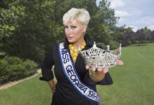 Kim Gravel smiling during a QVC fashion show, American TV host and entrepreneur presenting Belle by Kim Gravel collection in 2025.